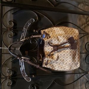 Like new Dooney & Bourke signature tan and brown canvas bucket bag